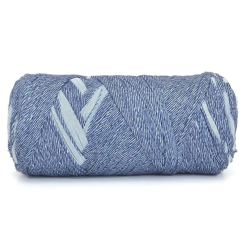 Rolled-up blue towel with white patterns on a white background