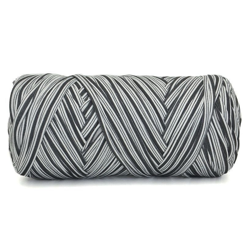 Black and white striped cylindrical pillow on a white background